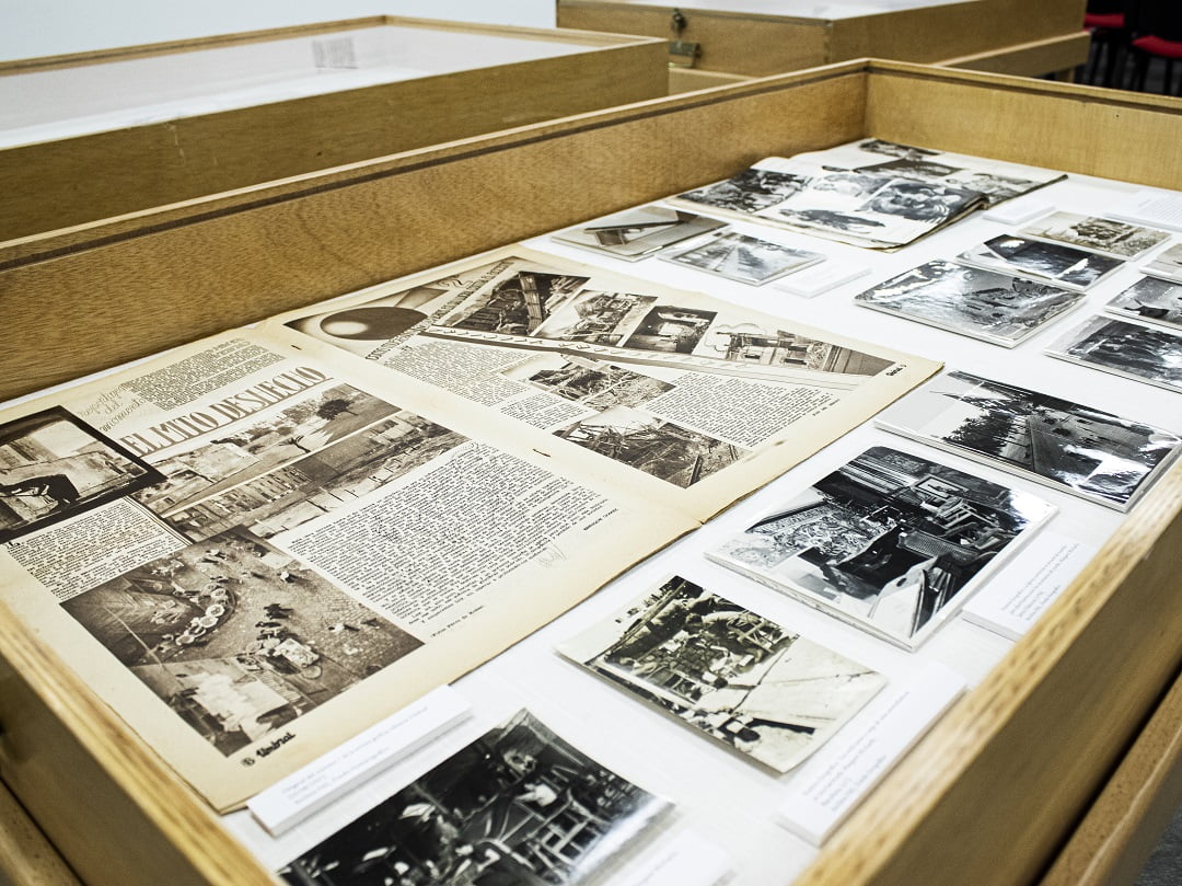 An exhibition case showing a historical anarchist magazine and photos